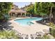 Community pool with ample seating in both sun and shade, surrounded by mature landscaping at 5104 N 32Nd St # 105, Phoenix, AZ 85018