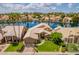 Stunning aerial view of a home nestled on a lake, showcasing its manicured lawn and lush surroundings at 518 S Bay Shore Blvd, Gilbert, AZ 85233