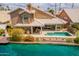 Inviting backyard with a private pool, covered patio, and direct access to the serene waterfront at 518 S Bay Shore Blvd, Gilbert, AZ 85233