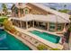 Inviting backyard featuring a private pool, covered patio, lush landscaping, and peaceful waterfront access at 518 S Bay Shore Blvd, Gilbert, AZ 85233