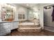 Bathroom featuring a soaking tub with tile surround, vanity, and walk-in closet at 518 S Bay Shore Blvd, Gilbert, AZ 85233