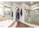 Bathroom with a soaking tub, dual sink vanity, walk-in closet, and glass enclosed shower at 518 S Bay Shore Blvd, Gilbert, AZ 85233