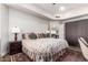 This bedroom features a king-size bed, a ceiling fan, and a view of the entryway at 518 S Bay Shore Blvd, Gilbert, AZ 85233
