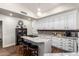 Modern kitchen with a large island, granite counters, white cabinets, and a display cabinet at 518 S Bay Shore Blvd, Gilbert, AZ 85233