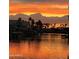 Waterfront homes reflecting in calm waters at sunset with dramatic cloudscape at 518 S Bay Shore Blvd, Gilbert, AZ 85233