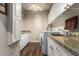 The laundry room has abundant cabinetry, granite countertops, and a washer/dryer with a utility sink at 518 S Bay Shore Blvd, Gilbert, AZ 85233