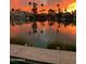 Beautiful sunset view of a lakefront community with palm trees reflecting on the water at 518 S Bay Shore Blvd, Gilbert, AZ 85233
