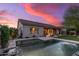 A backyard with a covered patio, pool, and sunset skies at 5813 E Ashler Hills Dr, Cave Creek, AZ 85331
