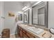 Bathroom featuring double sinks, framed mirrors, updated lighting, and plenty of counter space at 5813 E Ashler Hills Dr, Cave Creek, AZ 85331
