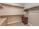 Spacious walk-in closet featuring wooden shelves, hanging rods, and built-in drawers for ample storage at 5813 E Ashler Hills Dr, Cave Creek, AZ 85331