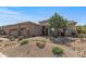 Single-story home with desert landscaping, a stone-accented facade, and a three-car garage at 5813 E Ashler Hills Dr, Cave Creek, AZ 85331