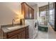 This laundry room features custom cabinets, granite countertops, a sink, a stacked washer and dryer, and a decorative accent wall at 5813 E Ashler Hills Dr, Cave Creek, AZ 85331