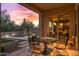 Covered patio overlooking the pool, landscaping, and views of the sunset at 5813 E Ashler Hills Dr, Cave Creek, AZ 85331