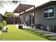Backyard with a pergola, patio furniture, and well-manicured artificial turf at 6335 E Brown Rd # 1084, Mesa, AZ 85205