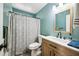 Updated bathroom features wood vanity, modern fixtures, stylish mirror, and shower/tub with whale curtain at 6335 E Brown Rd # 1084, Mesa, AZ 85205