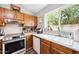 Bright updated kitchen showcasing oak cabinetry and stainless steel appliances at 6335 E Brown Rd # 1084, Mesa, AZ 85205