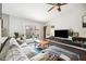Cozy living room with vaulted ceilings, a ceiling fan, and sliding glass doors leading to a green backyard at 6335 E Brown Rd # 1084, Mesa, AZ 85205