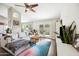 Open living area with modern furnishings, hardwood floors, access to backyard, and adjacent to the kitchen at 6335 E Brown Rd # 1084, Mesa, AZ 85205