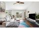 Bright living room with white sofa, modern entertainment center and patio access at 6335 E Brown Rd # 1084, Mesa, AZ 85205