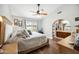 Main bedroom with ensuite bath, a ceiling fan, and private patio access at 6335 E Brown Rd # 1084, Mesa, AZ 85205