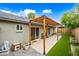 Backyard with patio under pergola with string lights, paver patio, artificial turf, and new landscaping at 6335 E Brown Rd # 1084, Mesa, AZ 85205
