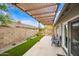 Backyard features a pergola with string lights over a patio and manicured landscaping at 6335 E Brown Rd # 1084, Mesa, AZ 85205