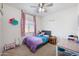 Charming bedroom featuring a plush bed, soft pink curtains, and a sunny window view at 697 E Ruby Dr, Casa Grande, AZ 85122