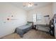 Cozy bedroom featuring neutral carpet, a single bed, and a window offering plenty of natural light at 697 E Ruby Dr, Casa Grande, AZ 85122
