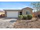 Charming single-story home featuring a two-car garage, low-maintenance landscaping and a desert-style front yard at 697 E Ruby Dr, Casa Grande, AZ 85122