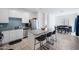 Modern kitchen with stainless steel appliances, granite countertops, island with barstools, and tile flooring at 697 E Ruby Dr, Casa Grande, AZ 85122