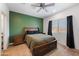 The main bedroom features a large window with a ceiling fan and green accent wall at 697 E Ruby Dr, Casa Grande, AZ 85122