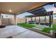 Inviting backyard featuring a pergola-covered patio, hot tub, manicured lawn, and ample space for outdoor relaxation and entertaining at 6983 W Andrea Dr, Peoria, AZ 85383