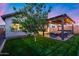 Inviting backyard features a pergola-covered patio with lights, hot tub, and comfortable seating for outdoor enjoyment and entertaining at 6983 W Andrea Dr, Peoria, AZ 85383