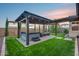 A backyard features a pergola-covered patio, hot tub, and outdoor seating with manicured lawn at 6983 W Andrea Dr, Peoria, AZ 85383