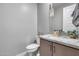 Well-lit powder room with granite countertops, modern fixtures, and neutral finishes at 6983 W Andrea Dr, Peoria, AZ 85383