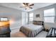 Neutral-toned bedroom with a double bed, ceiling fan, and ample natural light at 6983 W Andrea Dr, Peoria, AZ 85383