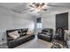 Comfortable bedroom with plush furniture, ceiling fan, and natural lighting at 6983 W Andrea Dr, Peoria, AZ 85383