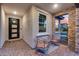 Cozy covered front porch with seating area, stylish decor, and welcoming ambiance at 6983 W Andrea Dr, Peoria, AZ 85383