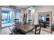 Bright dining area with wooden table, bench seating, and sliding glass doors to the outdoor living space at 6983 W Andrea Dr, Peoria, AZ 85383