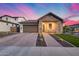 Charming single-story home with brick driveway, two-car garage, and inviting covered porch under a colorful sky at 6983 W Andrea Dr, Peoria, AZ 85383