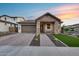Beautiful home with desert landscaping, brick accents, two-car garage, and covered front porch at 6983 W Andrea Dr, Peoria, AZ 85383