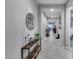 Inviting hallway with tiled flooring, decorative console table, and access to other rooms at 6983 W Andrea Dr, Peoria, AZ 85383