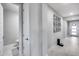 Hallway with access to the bathroom, art decor, and entry with gray tile flooring at 6983 W Andrea Dr, Peoria, AZ 85383