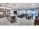 Open-concept layout with a large island, stainless appliances, and adjoining living/dining areas at 6983 W Andrea Dr, Peoria, AZ 85383