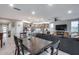 Open floor plan featuring a kitchen with a breakfast bar overlooking the living room and dining area at 6983 W Andrea Dr, Peoria, AZ 85383