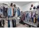 Walk-in closet offering ample hanging and storage space on built-in shelves with carpet flooring at 6983 W Andrea Dr, Peoria, AZ 85383