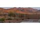 Scenic backyard view showcasing mountain scenery, a secure fence, and desert-style landscaping with a stone patio at 7659 S 164Th Ln, Goodyear, AZ 85338