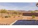 Expansive backyard featuring mountain views, gravel landscaping, and a paved patio perfect for outdoor relaxation at 7659 S 164Th Ln, Goodyear, AZ 85338