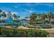 Resort-style community pool with lighthouse, waterslide, palm trees and lake views at 7659 S 164Th Ln, Goodyear, AZ 85338