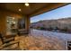 Covered patio with comfortable seating overlooking a desert landscape with mountain views at 7659 S 164Th Ln, Goodyear, AZ 85338